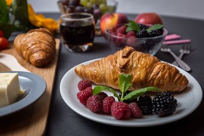 Close-up of croissants with berries on table