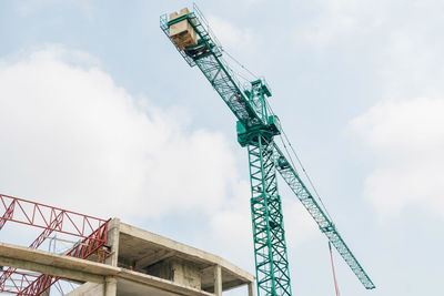 Low angle view of crane against sky