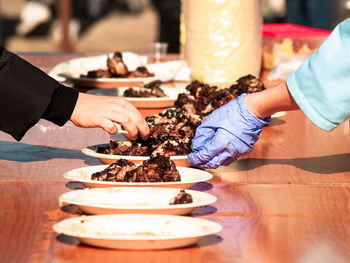Cropped image of people holding food