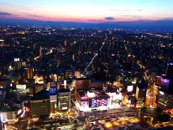 Aerial view of illuminated city at night