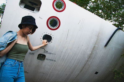 Man holding woman standing against wall