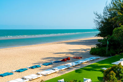 Scenic view of beach against clear blue sky