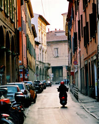 People driving scooter in street