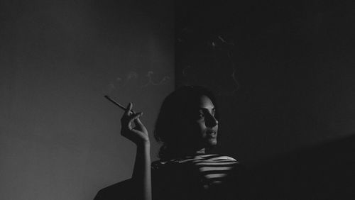 Portrait of a young woman smoking