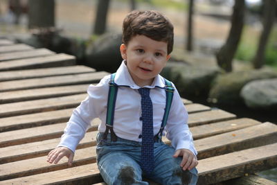 Portrait of smiling boy sitting in park