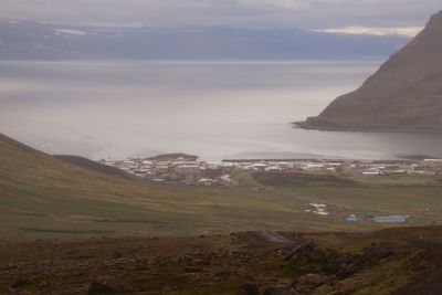 Scenic view of sea and mountains against sky