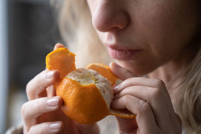 Close-up of woman eating orange
