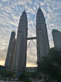 Low angle view of buildings against cloudy sky
