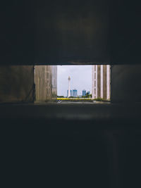 Man standing by window in city