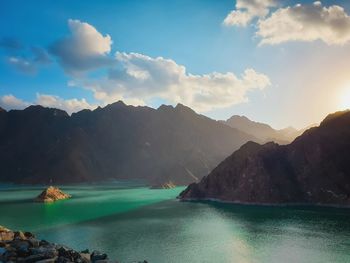 Scenic view of lake against cloudy sky