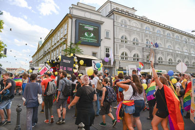 Crowd in city against sky