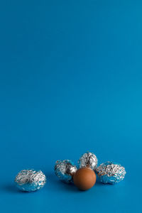 High angle view of candies against blue background