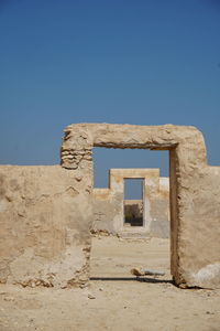 Old ruin building against clear blue sky