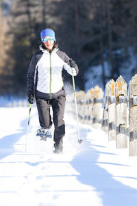 Full length of man with umbrella on snow