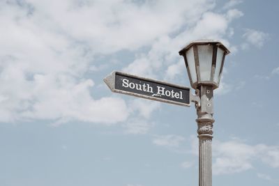 Low angle view of road sign against sky