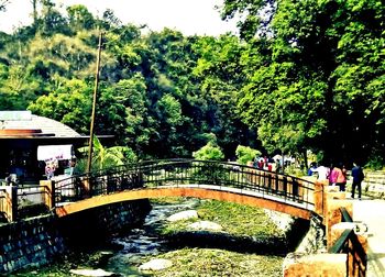 Woman leaning on footbridge