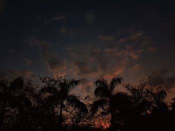 Low angle view of silhouette trees against sky at sunset