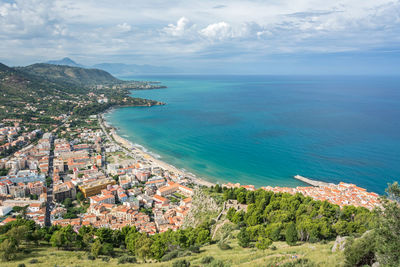 High angle view of townscape by sea against sky