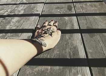 Cropped hand of woman with tattoo