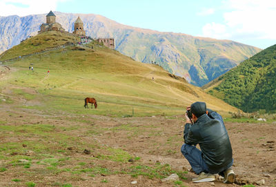 High angel view of man photographing on field