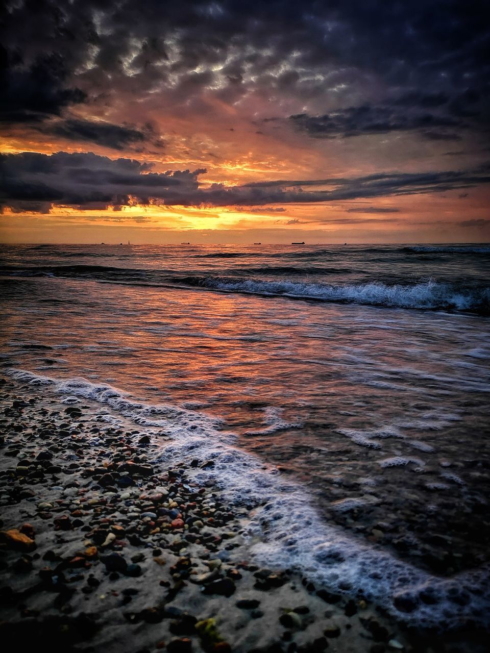 SCENIC VIEW OF BEACH AGAINST SKY DURING SUNSET