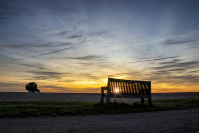 Sunrise over maggi hambling's sculpture of the scallop on the shingle beach in aldeburgh, uk