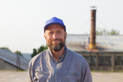 Portrait of smiling man standing outdoors