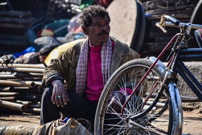 Man sitting on bicycle in city