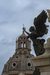 Low angle view of statue of building against sky