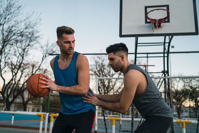 Young man playing with basketball