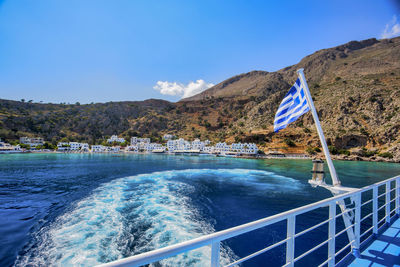 Scenic view of swimming pool by sea against blue sky