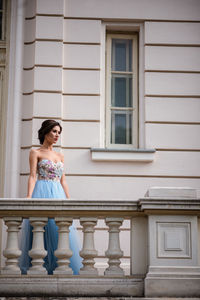 Full length of woman sitting against building