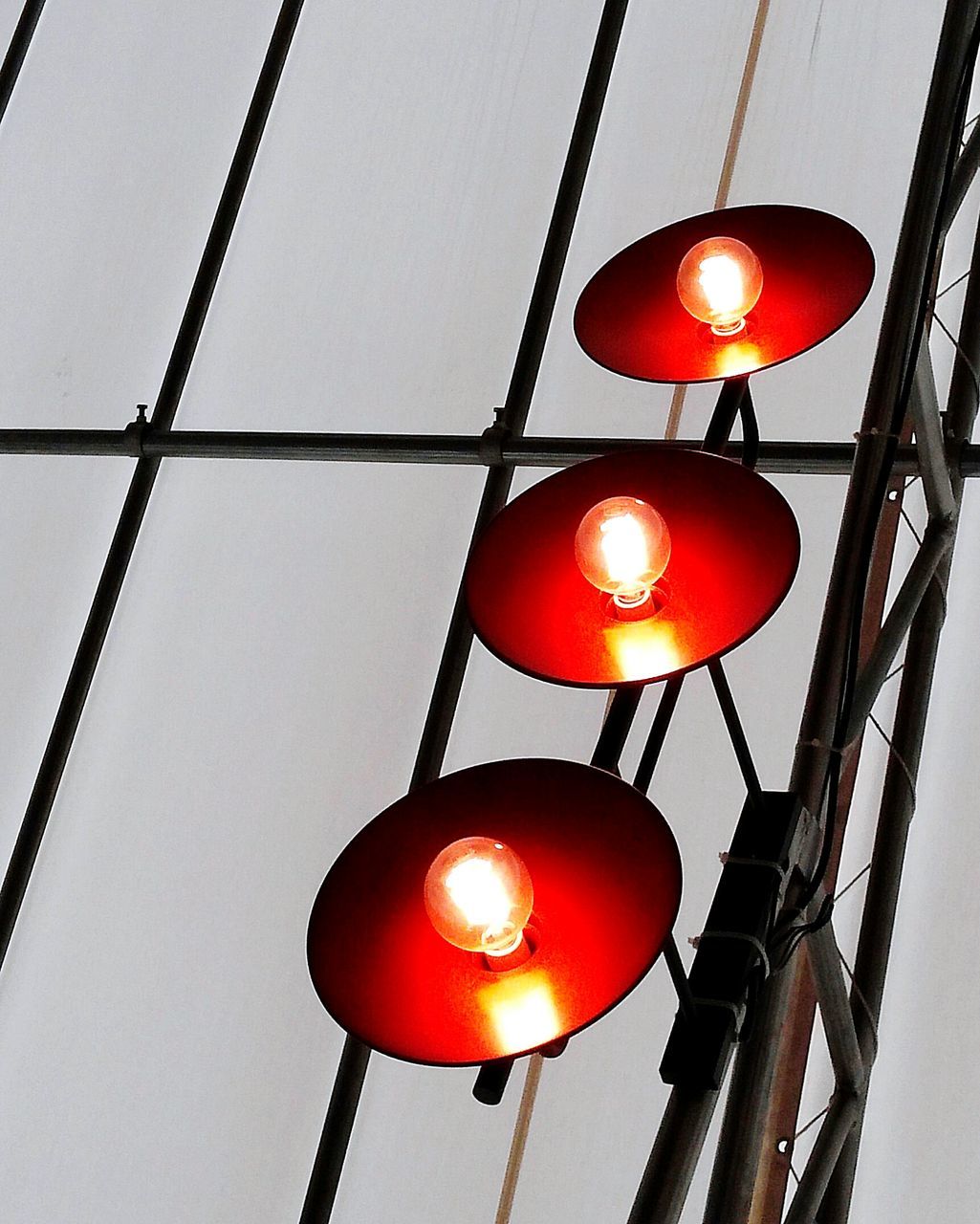 low angle view, lighting equipment, illuminated, hanging, electricity, light bulb, indoors, electric light, ceiling, glowing, lantern, decoration, electric lamp, metal, light - natural phenomenon, technology, lit, fuel and power generation, close-up, lamp