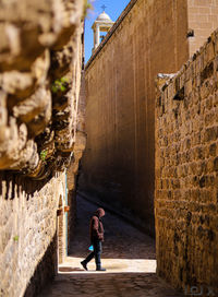 Full length of woman walking on old building