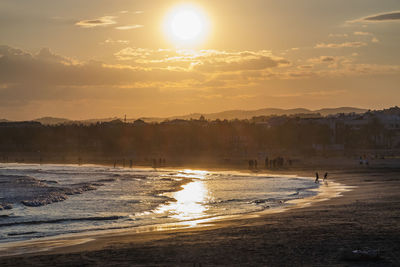 Scenic view of beach against sky during sunset