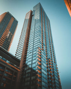 Low angle view of modern buildings against clear sky