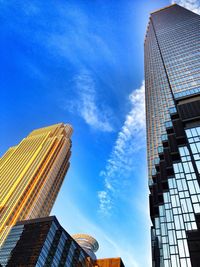 Low angle view of modern building against blue sky