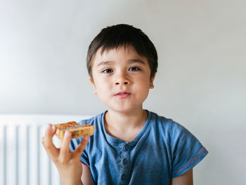 Portrait of cute boy eating food