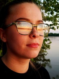 Close-up of woman wearing eyeglasses looking away