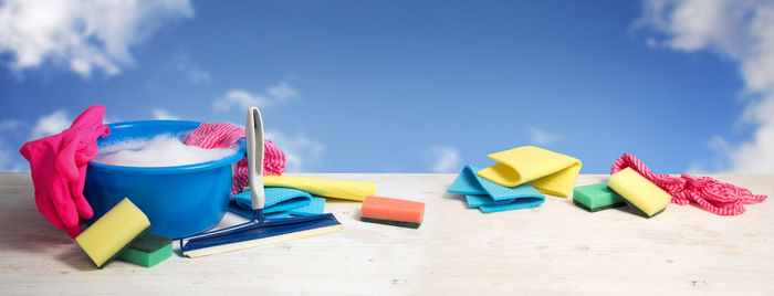 Cleaning equipment on table against sky