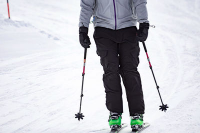 Low section of people skiing on snow