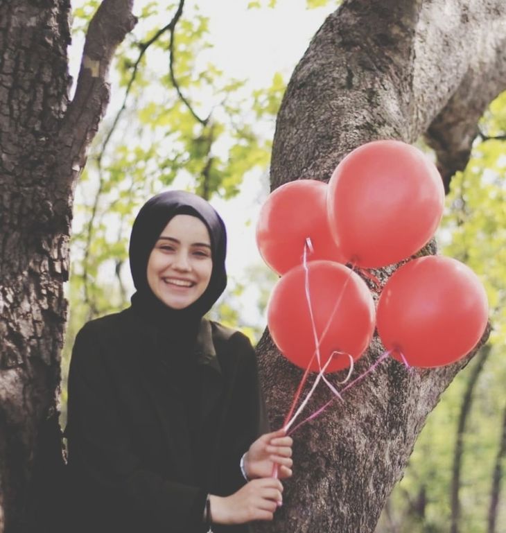 smiling, tree, happiness, young adult, one person, tree trunk, trunk, real people, plant, emotion, looking at camera, leisure activity, lifestyles, nature, portrait, young women, balloon, day, women, outdoors, beautiful woman