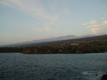 Scenic view of river and mountains against sky