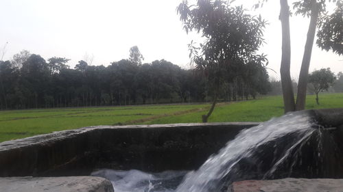 Scenic view of waterfall against sky
