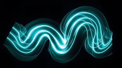 Close-up of light painting against black background