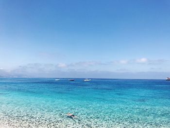 Scenic view of sea against clear blue sky