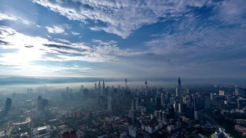 High angle view of modern buildings in city against sky