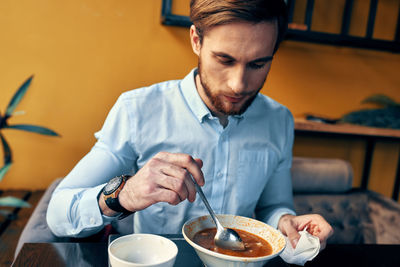 Midsection of man holding ice cream