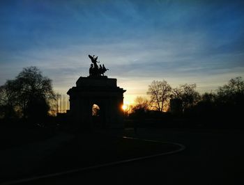 Built structure against sky at sunset