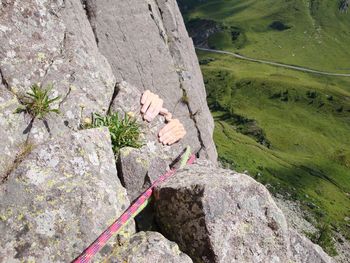 High angle view of woman hands on rock over landscape